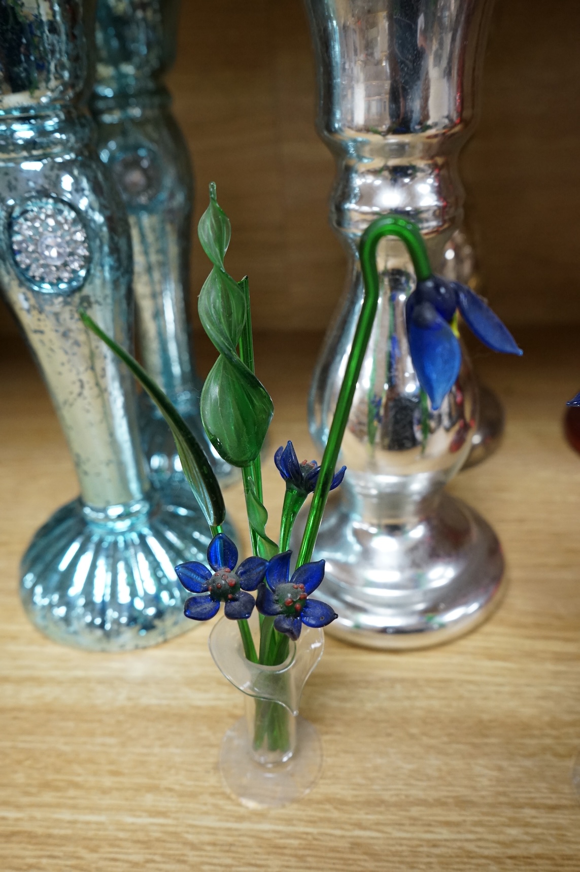 Three pairs of mirrored glass candlesticks and two small glass floral displays, largest 26cm high